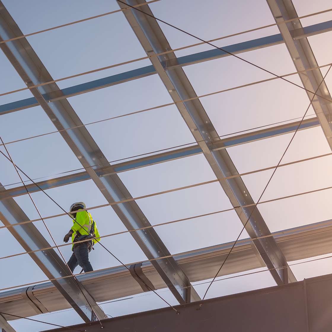 VP Builder standing on top of a steel metal building frame. 